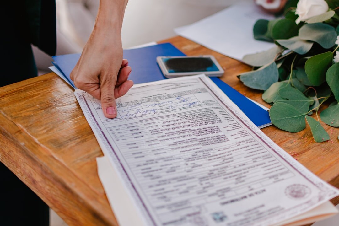 Close-up of hands signing a legal document